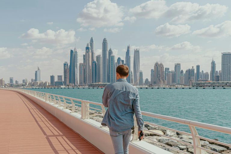 Man walking along dubai marina promenade